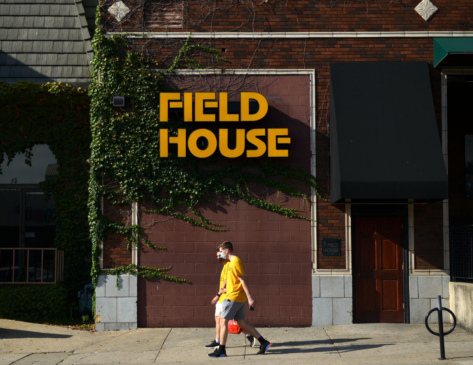Pedestrians walk by Field House bar
